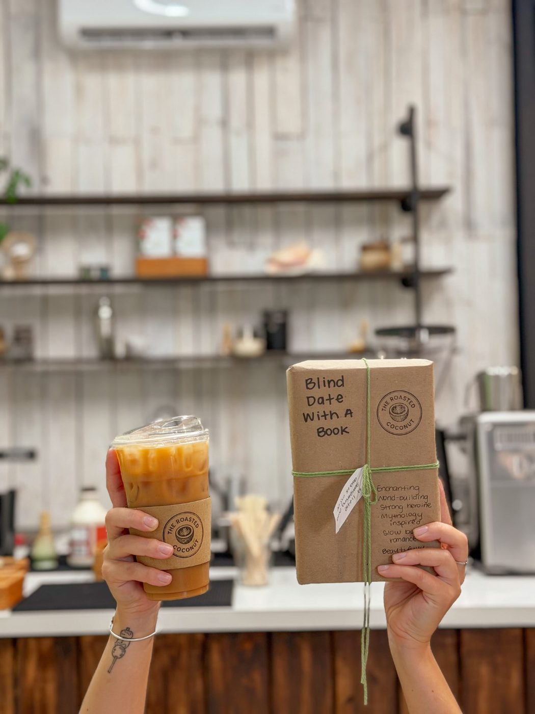 Wrapped Blind Date With A Book beside an iced coffee
